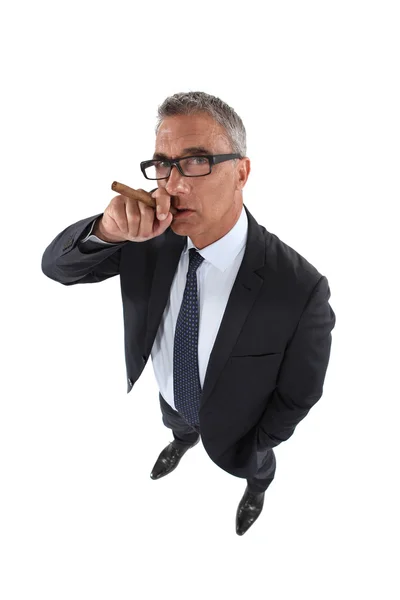 Senior businessman smoking cigar — Stock Photo, Image