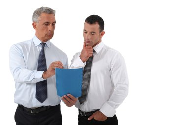 Businessmen looking at a report clipart