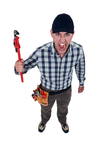 Angry plumber holding wrench — Stock Photo, Image