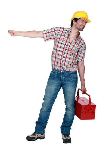 Tradesman puxando um objeto pesado — Fotografia de Stock