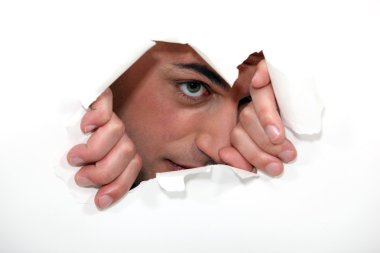 Man looking through hole in paper clipart