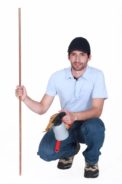 Man with copper pipe and a blowtorch — Stock Photo, Image