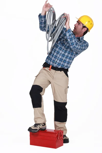 Electrician swamped with cables — Stock Photo, Image