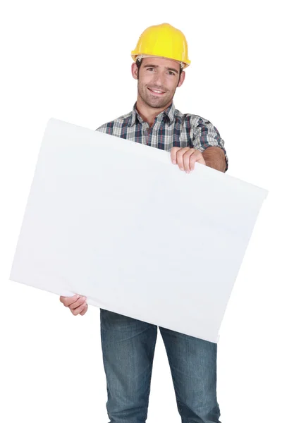 Male construction worker holding blank advertising board — Stock Photo, Image