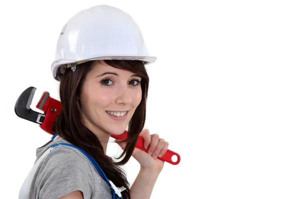 Woman resting wrench on shoulder — Stock Photo, Image