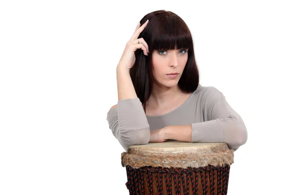 Pensive woman resting on a drum — Stock Photo, Image