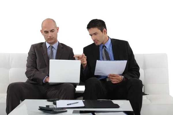 Two businessman working at home. Stock Image