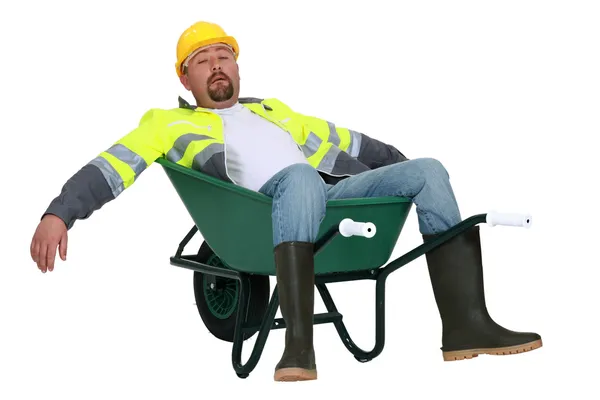 Utmattad builder om i skottkärra — Stockfoto