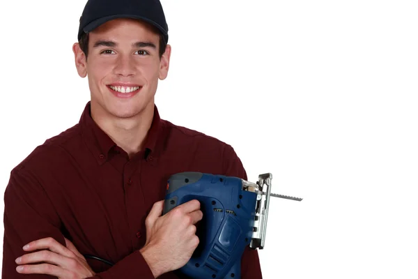 Young man holding a jigsaw — Stock Photo, Image