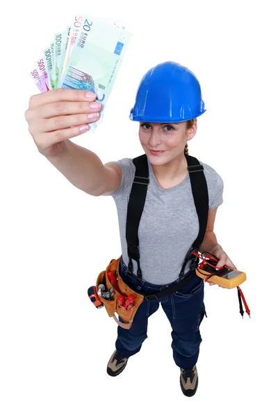 Electrician with a handful of cash — Stock Photo, Image