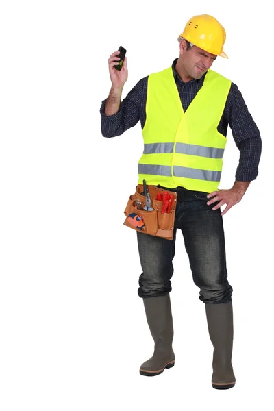 Builder being shouted at over the telephone — Stock Photo, Image