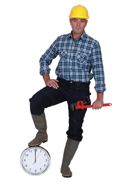 Construction worker with a clock — Stock Photo, Image