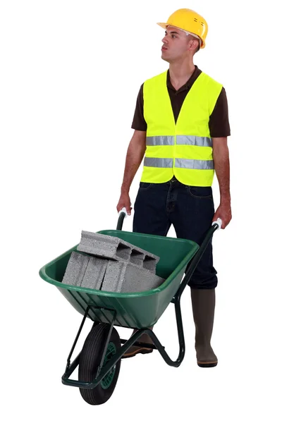 Mason pushing wheelbarrow — Stock Photo, Image