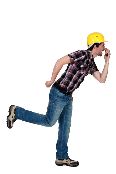 Goofy tradesman holding an object up to his nose — Stock Photo, Image