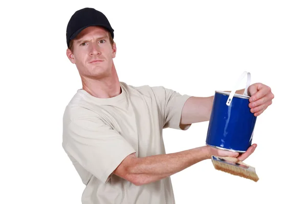 Decorator holding tin of blue paint — Stock Photo, Image