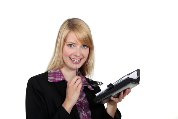 Attractive woman looking at her agenda — Stock Photo, Image