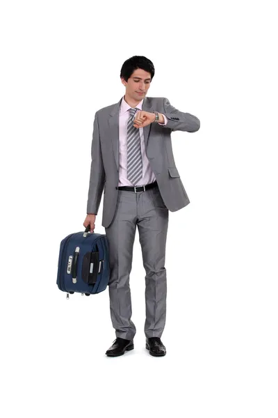 Man with suitcase looking at the time — Stock Photo, Image