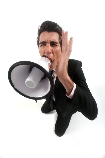 Businessman shouting through megaphone — Stock Photo, Image