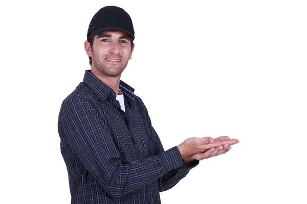 Man in a cap holding blank copyspace — Stock Photo, Image