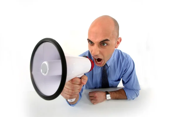 Angry businessman shouting in loudspeaker — Stock Photo, Image