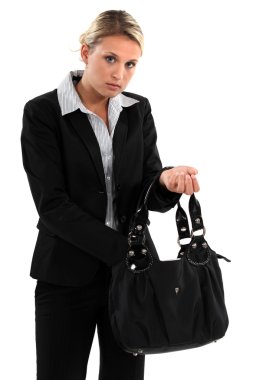 Woman searching for something in her bag clipart