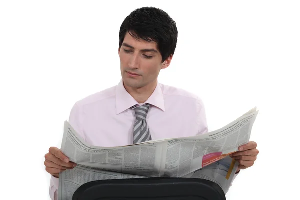 Young businessman reading newspaper — Stock Photo, Image