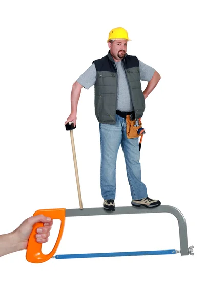 Worker standing on a hacksaw — Stock Photo, Image