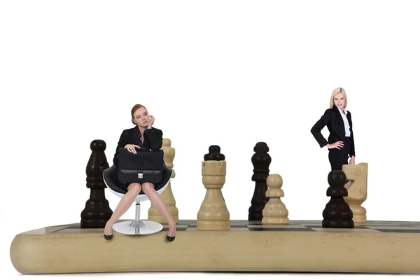 Two women on giant chessboard — Stock Photo, Image