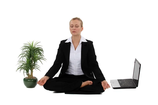 Businesswoman meditating next to her laptop — Stock Photo, Image