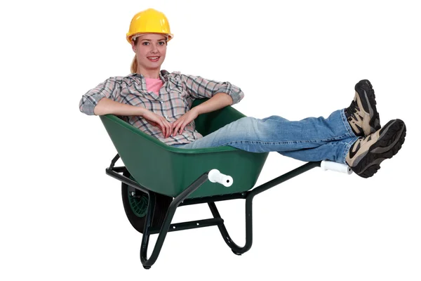 Construction worker sitting in a wheelbarrow — Stock Photo, Image