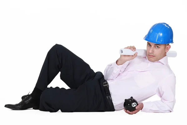 Architect posing with piggy bank — Stock Photo, Image