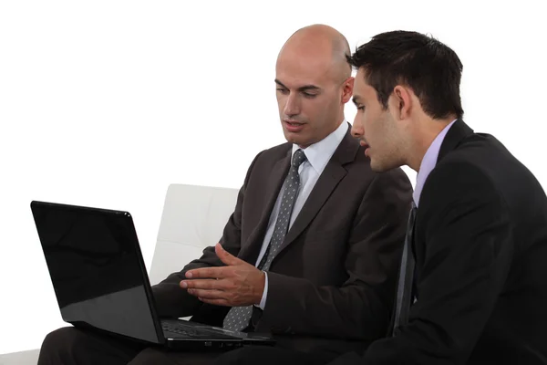 Two businessmen using laptop — Stock Photo, Image