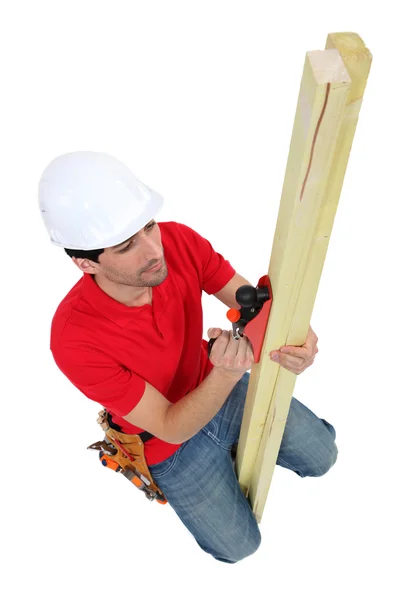 Carpenter planing wood — Stock Photo, Image