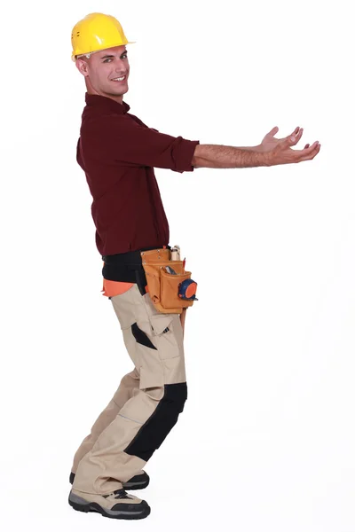 Tradesman carrying an invisible object — Stock Photo, Image