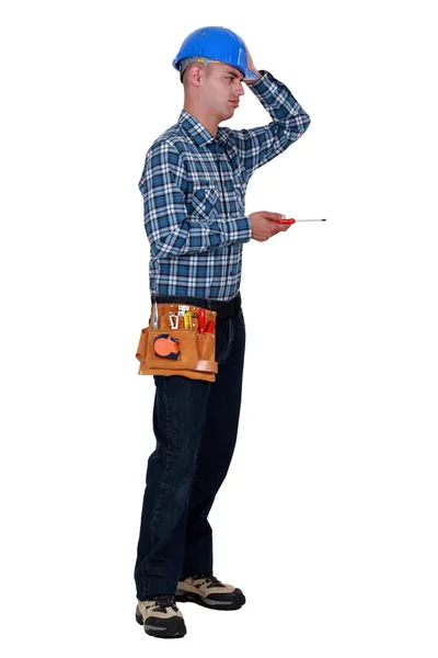 Annoyed tradesman performing a tedious task — Stock Photo, Image