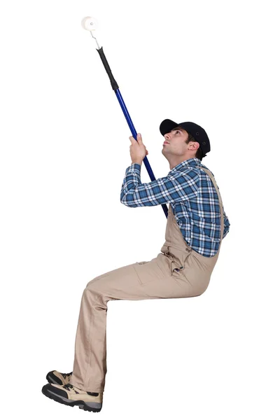 Man painting a ceiling with a roller — Stock Photo, Image