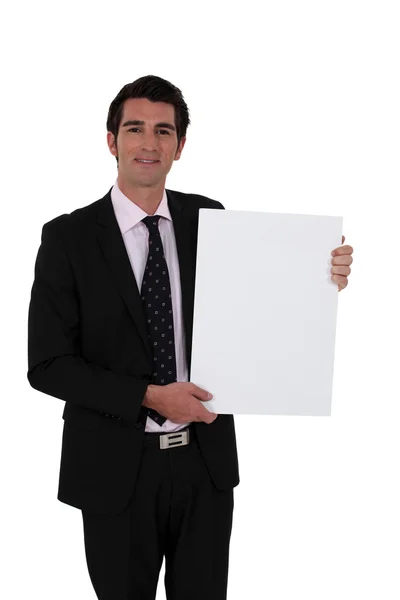 Smart businessman making presentation against white background — Stock Photo, Image