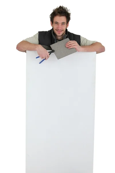 Tiler holding an ad board — Stock Photo, Image