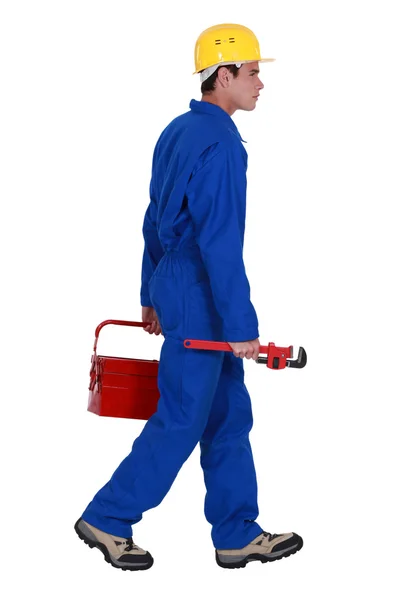 Plumber walking with toolbox and spanner — Stock Photo, Image