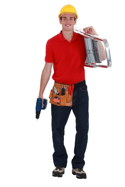 Happy young carpenter carrying ladder isolated on white — Stock Photo, Image