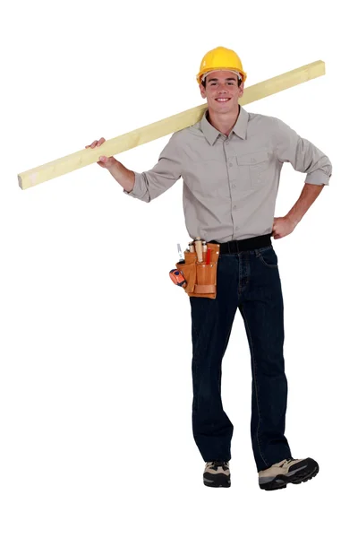 Young builder carrying timber — Stock Photo, Image