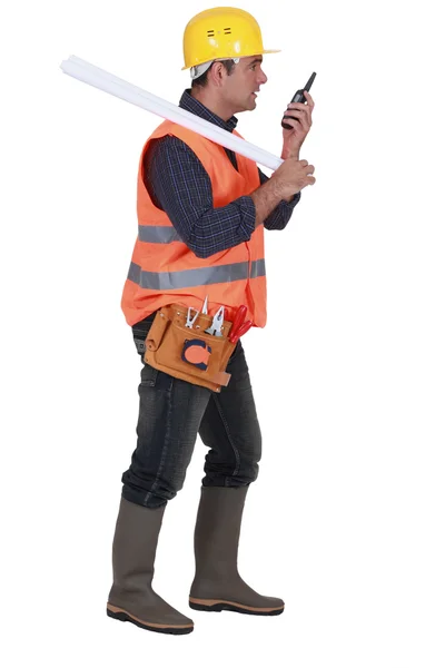 Foreman with blueprints over his shoulder and talkie walkie — Stock Photo, Image