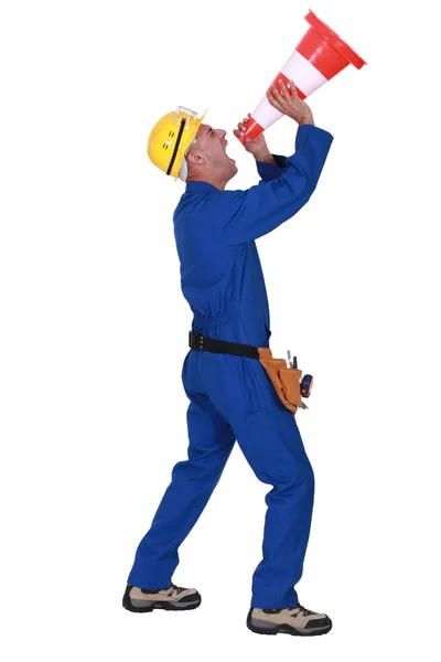 Worker shouting into traffic cone — Stock Photo, Image