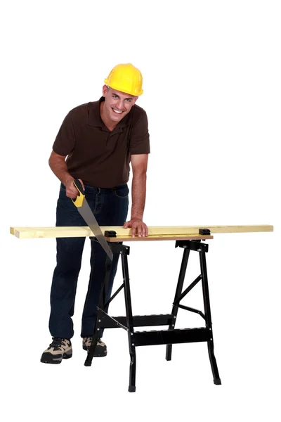 Man sawing plank of wood — Stock Photo, Image