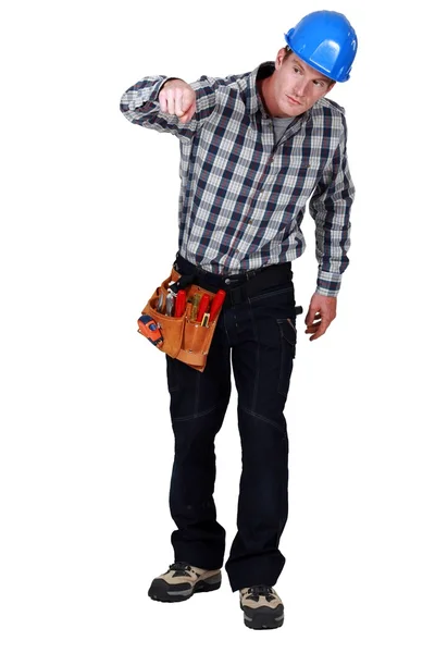 Curious tradesman pressing a button — Stock Photo, Image