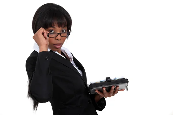 Businesswoman peering over her glasses — Stock Photo, Image