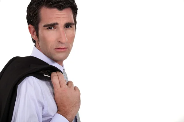 Serious man in suit holding his jacket — Stock Photo, Image