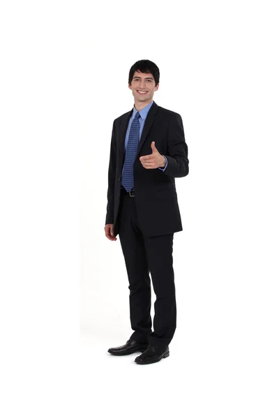 Young businessman giving thumbs-up gesture — Stock Photo, Image