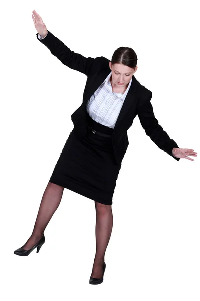 Female businesswoman miming tightrope walker — Stock Photo, Image