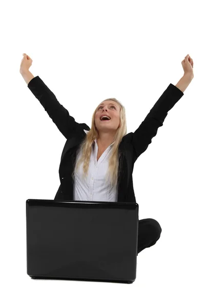 Triumphant businesswoman sitting at a laptop Royalty Free Stock Photos